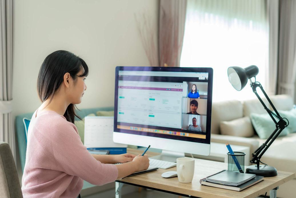 Woman on a video call on her desktop computer.