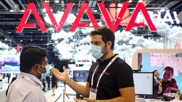 Avaya employee speaking with another person at an event.