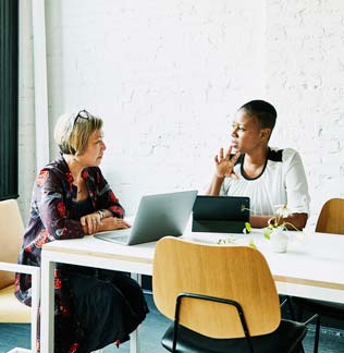 Businesswoman meeting with financial advisor in office conference room