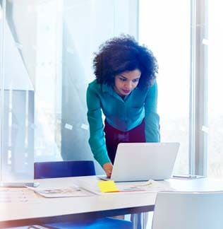 Woman looking at computer in office