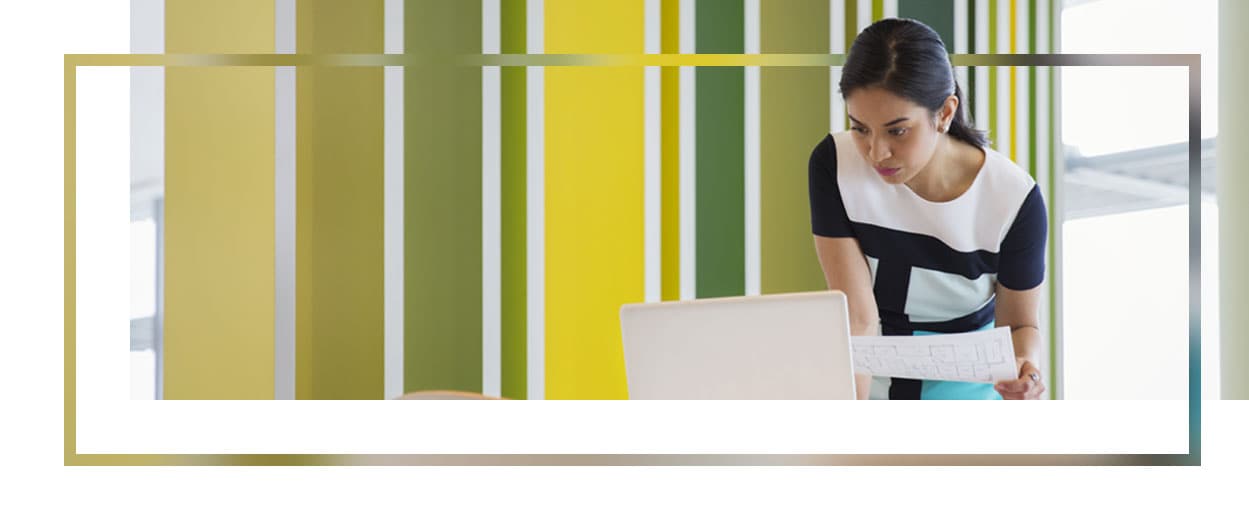 Woman working in a colorful office on her laptop