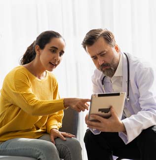 Doctor showing a patient results on a tablet