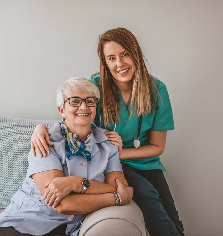 Senior woman with a female doctor on a home visit