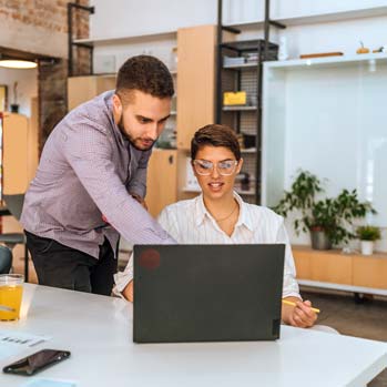 Coworkers working on project together in the office