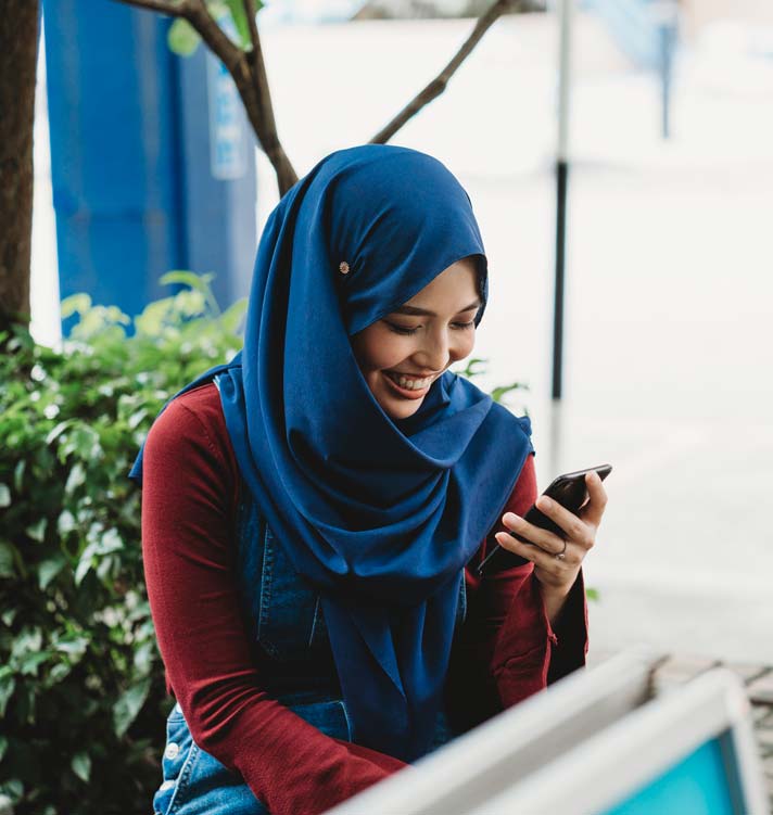 Woman using the mobile phone outdoors.