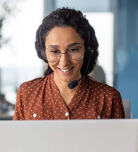 Female call center agent with orange polka dot shirt on