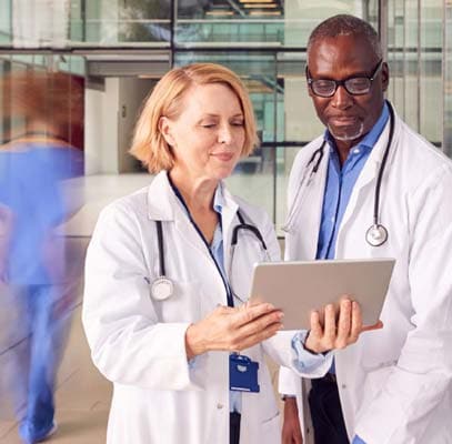 Two medical professionals looking at notes