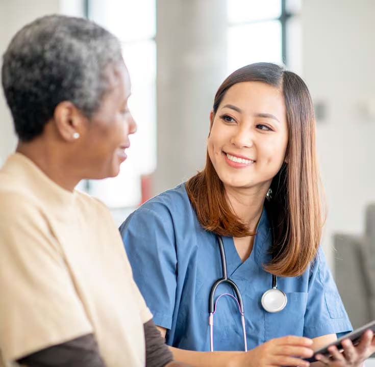 Smiling doctor sitting with patient