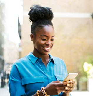 Smiling woman scrolling through her phone