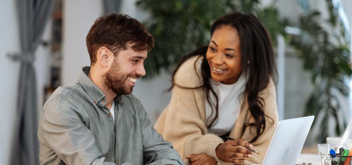 Two coworkers together in modern office