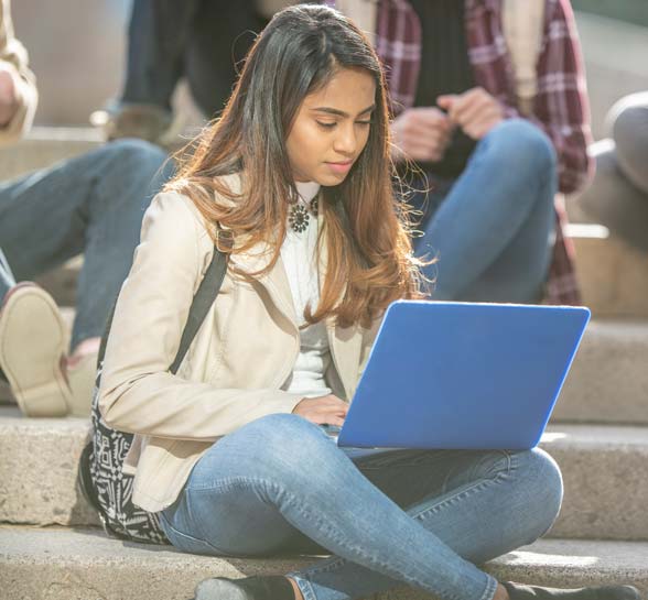 University Student Studying Outside On Break