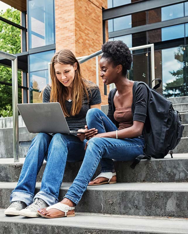 Two Female College Students on Campus with Laptop