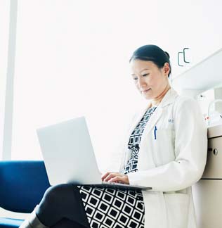 Businesswoman working late on a computer in an office