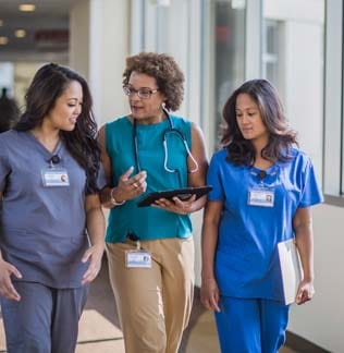 Nurses and doctor using digital tablet