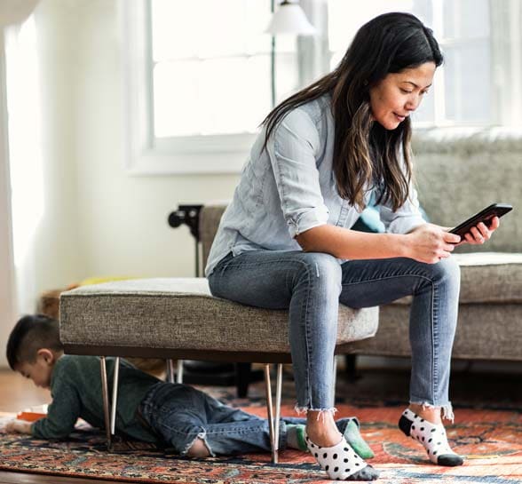 Woman sitting on a couch using her mobile phone