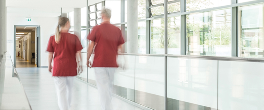 Two doctors walking down a hospital hall