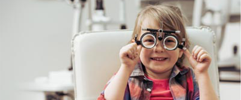 Child with eyesight measuring machine on