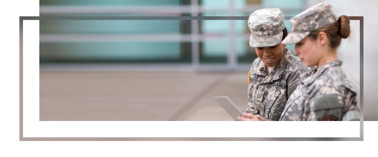 Two soldiers looking at a tablet