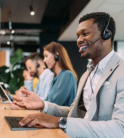 African American male contact center agent in a call center taking a call