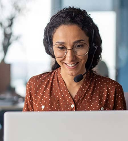 Female call center agent with orange polka dot shirt on