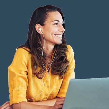 Smiling woman at her laptop with headphones