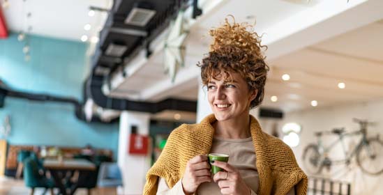 Woman standing while enjoying a cup of coffee