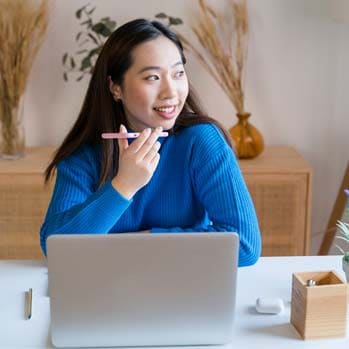 Woman working on laptop at home 