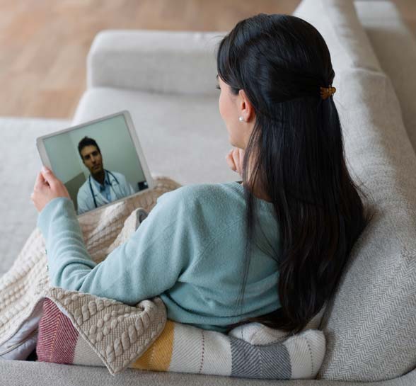 Woman at home talking to her doctor on a video call