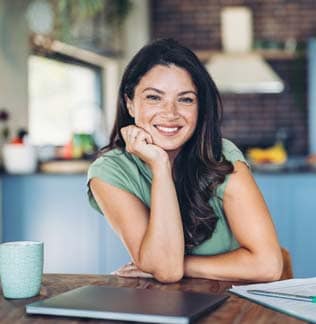 Smiling businesswoman at desk in office