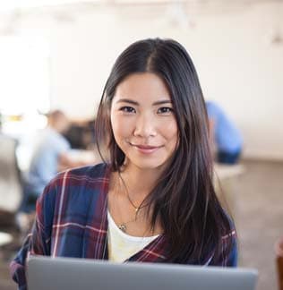 Businesswoman using laptop in modern office