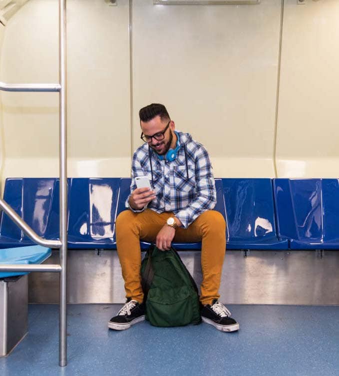 Man Using Mobile Phone While Sitting In Train