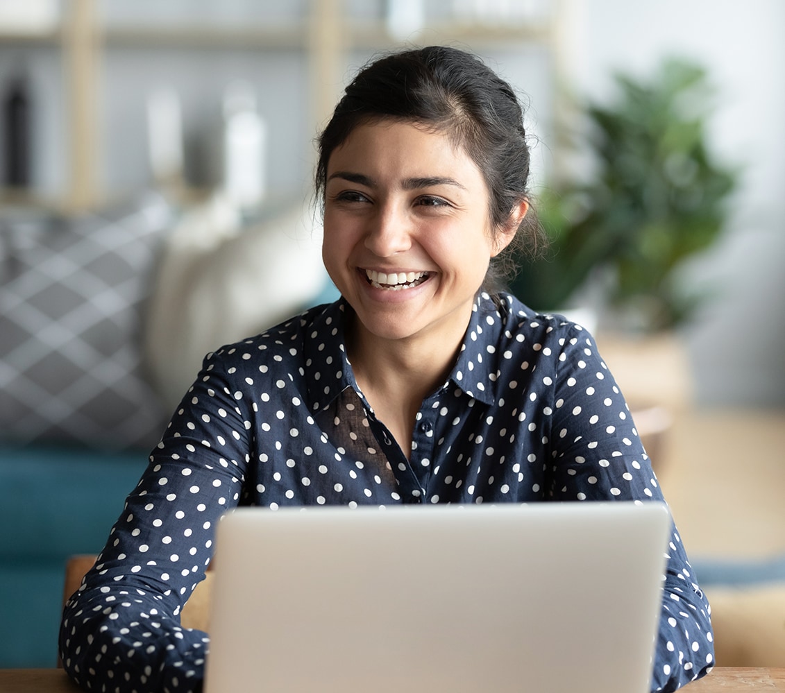 Smiling woman in front of laptop