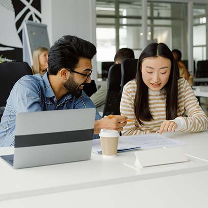 Two co-workers reviewing a doc in the office