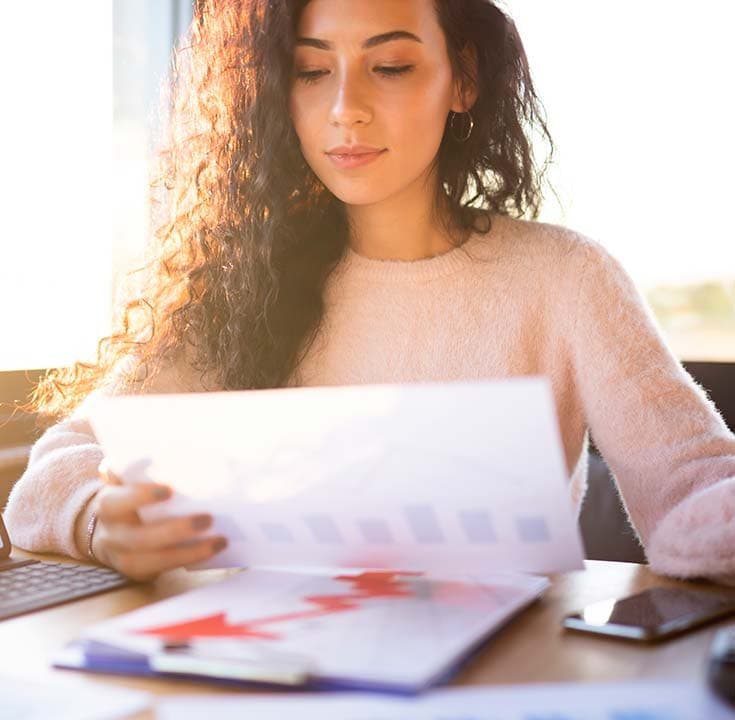 Businesswoman looking at a revenue chart