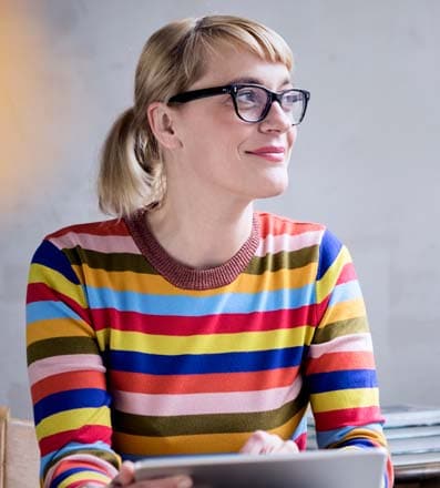 Woman with glasses in multicolored shirt