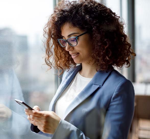 Businesswoman using smart phone in office