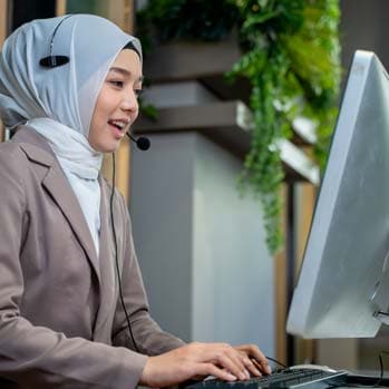 Friendly operator woman agent with headsets working in a call centre