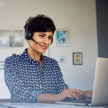 Contact center agent working remotely in her kitchen