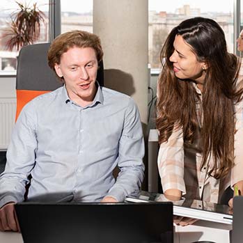 A man and a woman talking in an office