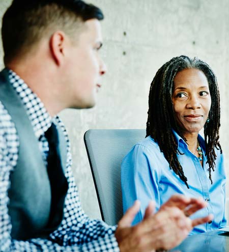 Coworkers in discussion during project meeting