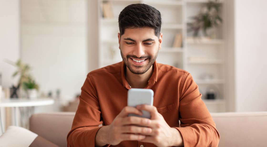 Man working remotely on PC sitting on his couch