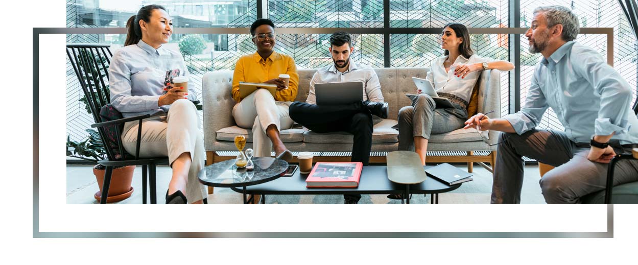 Happy business people having discussion during meeting in office.