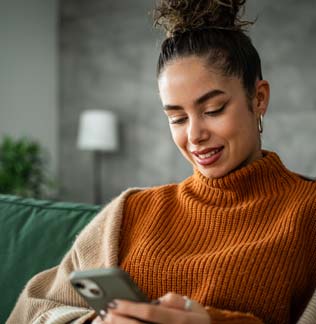 Woman at home using her mobile phone