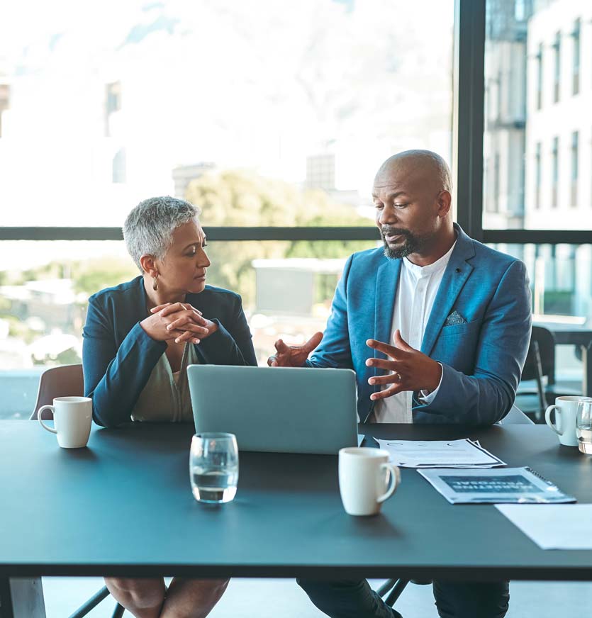 Business colleagues having discussion in office in front of laptop