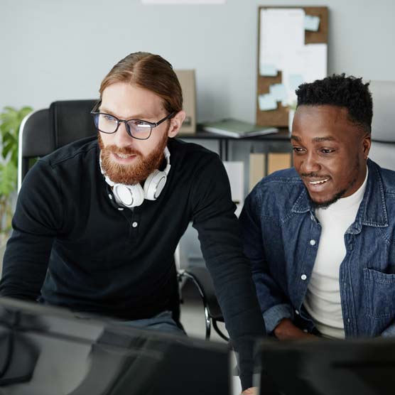 Happy coworkers working together on a computer