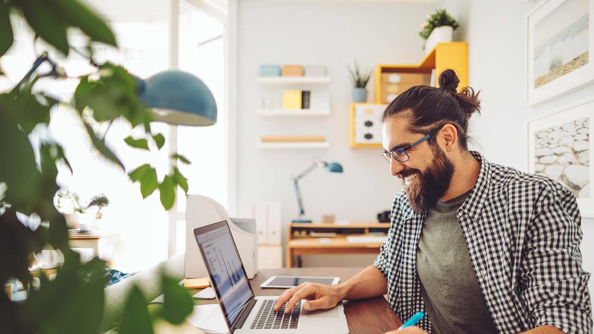 Man sitting at table working on laptop