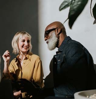 A stylish man and woman sitting together