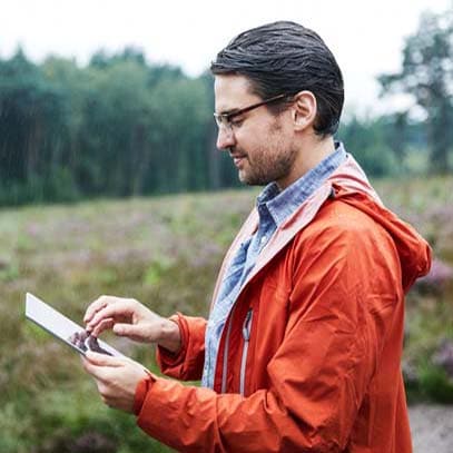 Man with tablet in landscape