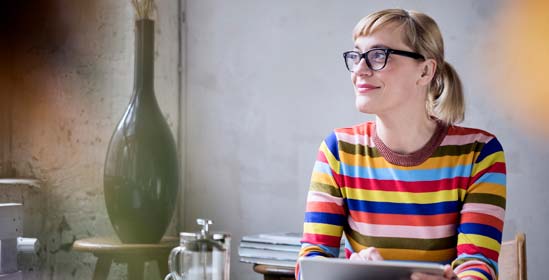 Woman sat in an office, smiling