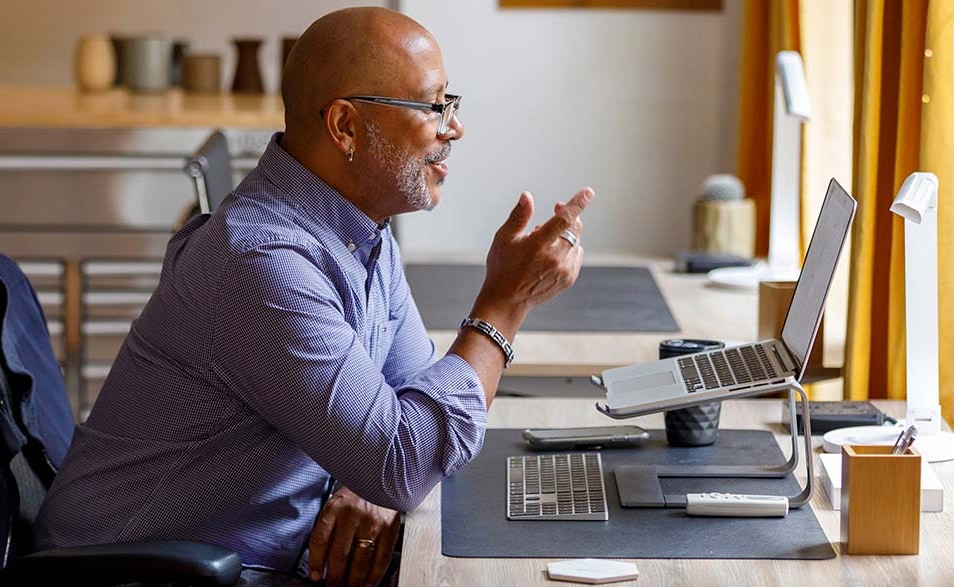 A image of a man looking at his laptop.